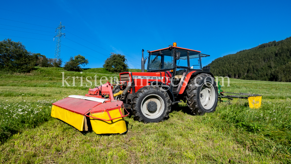 Traktor beim Mähen in Patsch, Tirol, Austria by kristen-images.com