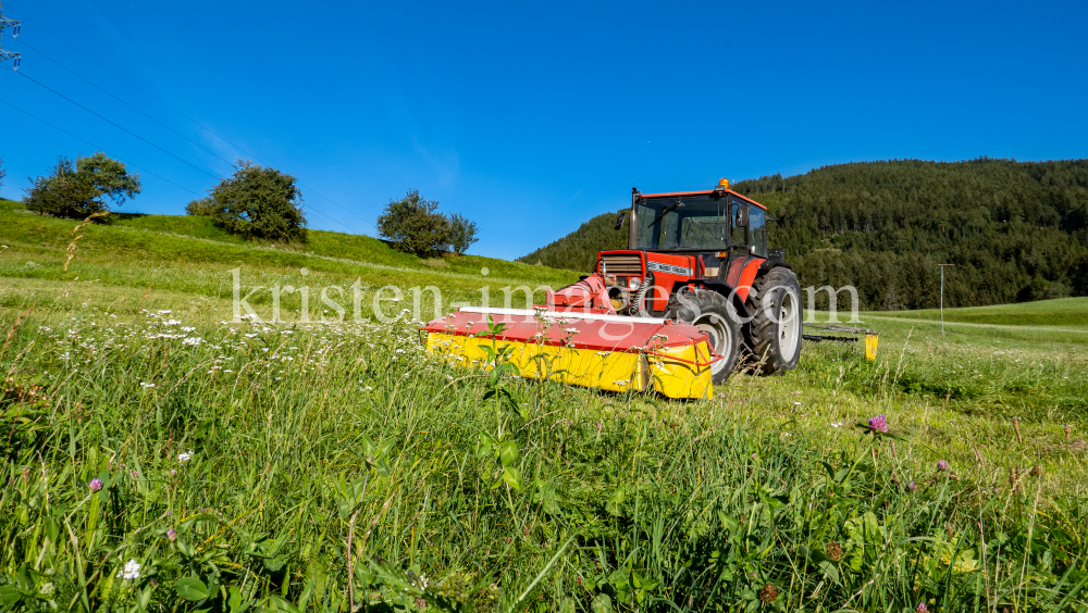 Traktor beim Mähen in Patsch, Tirol, Austria by kristen-images.com