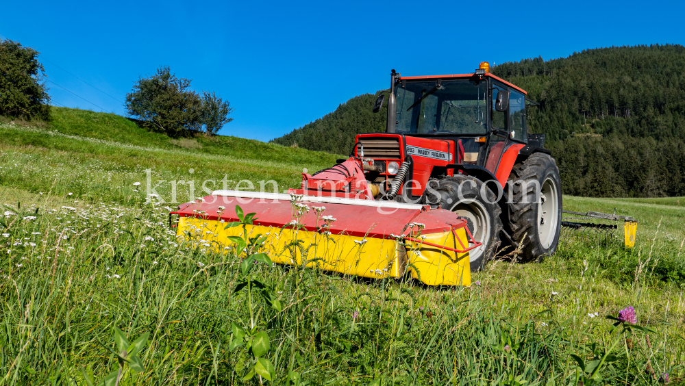 Traktor beim Mähen in Patsch, Tirol, Austria by kristen-images.com