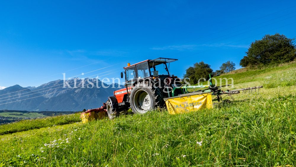 Traktor beim Mähen in Patsch, Tirol, Austria by kristen-images.com