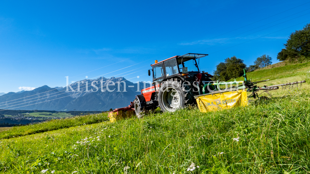 Traktor beim Mähen in Patsch, Tirol, Austria by kristen-images.com