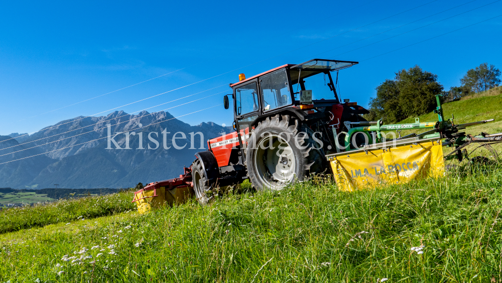 Traktor beim Mähen in Patsch, Tirol, Austria by kristen-images.com
