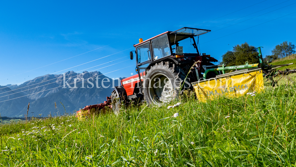 Traktor beim Mähen in Patsch, Tirol, Austria by kristen-images.com