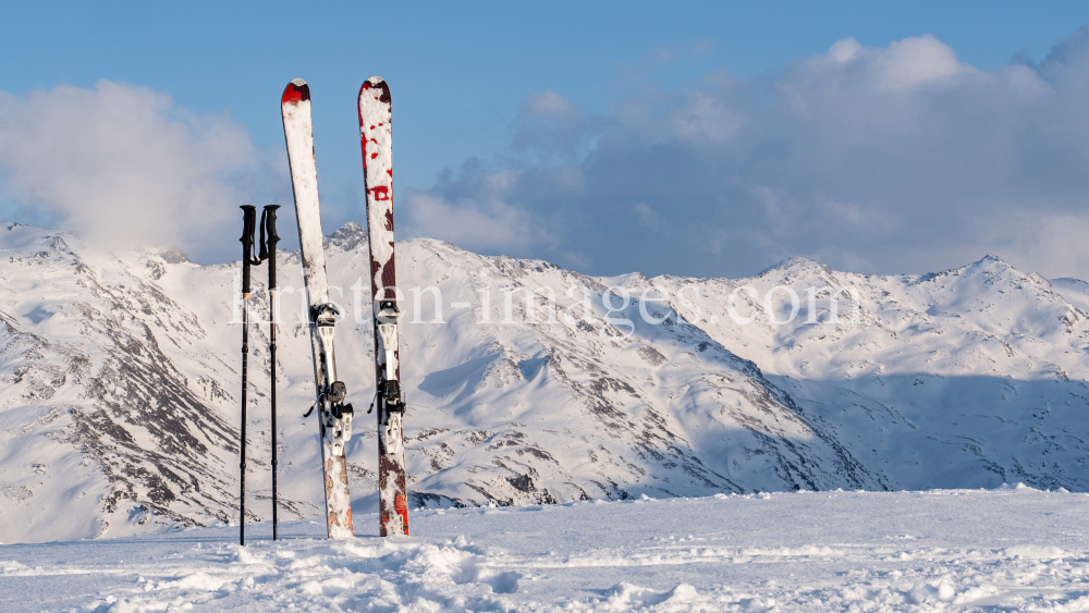 Ski und Skistöcke stecken im Schnee  by kristen-images.com