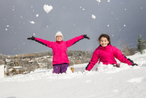Kinder freuen sich über den Neuschnee