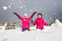 Kinder freuen sich über den Neuschnee