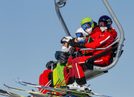 Skifahrer mit Maske am Sessellift